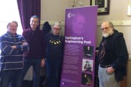 Four people stood next to the banner, which has the title 'Darlington's Engineering Past'